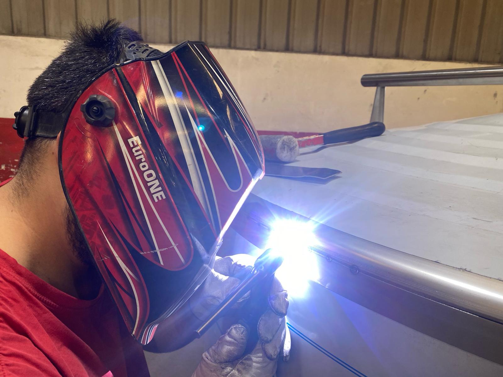 Aquafil technician welding stainless steel treatment equipment in the factory